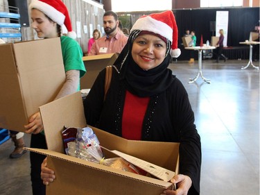 Kulsoom Quasim, with Innovapost, volunteered at the Hamper Packing Day, held at the Horticulture Building at Lansdowne on Wednesday, December 21, 2016, in support of the Christmas Exchange Program run by the Caring and Sharing Exchange.