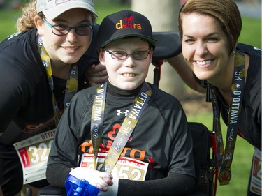 From left, Noemy Pitre, Jonathan Pitre and their mom, Tina Boileau, after finishing a 5K race in May 2016.