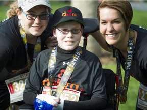 Left to right: Noemy Pitre, her brother, Jonathan Pitre, and their mother, Tina Boileau, after finishing the 5K race part of Tamarack Ottawa Race Weekend May 28, 2016. Photo: Ashley Fraser
