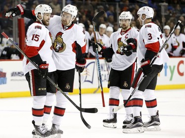 Ottawa Senators' right wing Mark Stone (61) celebrates with Senators' center Zack Smith (15) after Smith scored a goal during the first period of an NHL hockey game, Sunday, Dec. 18, 2016, in New York.