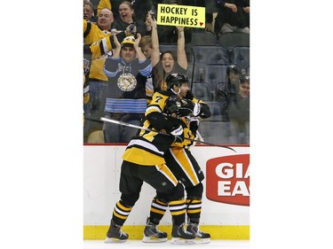 Pittsburgh Penguins' Matt Cullen (7) celebrates his goal with Bryan Rust (17) in the second period of an NHL hockey game against the Ottawa Senators in Pittsburgh, Monday, Dec. 5, 2016.