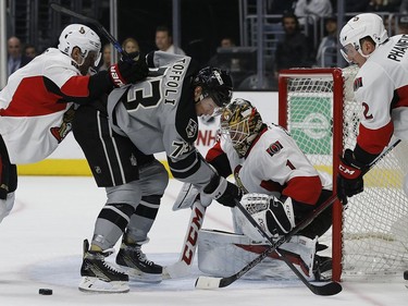 Ottawa Senators goalie Mike Condon rejects a shot by Los Angeles Kings centre Tyler Toffoli with defenceman Dion Phaneuf, right, and center Kyle Turris, left, defending during the second period of an NHL hockey game in Los Angeles on Saturday, Dec. 10, 2016.