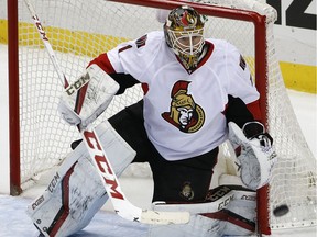 Ottawa Senators goalie Mike Condon (1) blocks a shot during the third period of an NHL hockey game against the Pittsburgh Penguins in Pittsburgh, Monday, Dec. 5, 2016. The Penguins won 8-5.