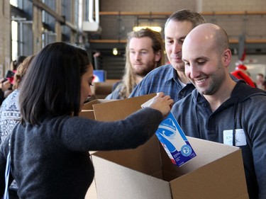 More than 200 volunteers, many from corporate sponsors, came out to help with the Hamper Packing Day held at the Horticulture Building at Lansdowne on Wednesday, December 21, 2016, in support of the Christmas Exchange Program run by the Caring and Sharing Exchange non-profit organization.