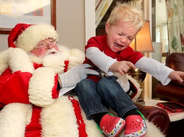 Not everyone was happy to see the big jolly fella at Ronald McDonald House Thursday (Dec. 15/2016) as the United States Marine Corp. and US. Navy brought hundreds of toys for sick kids along with American ambassador, Bruce Heyman. Like his twin brother, Axiom Huff-Boyle, 21 mos., howled and struggled to get away within seconds of being plopped on Santa's knee. He and his brother were only visitors at the house, where his grandmother volunteers.