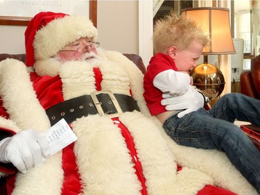 Not everyone was happy to see the big jolly fella at Ronald McDonald House Thursday (Dec. 15/2016) as the United States Marine Corp. and US. Navy brought hundreds of toys for sick kids along with American ambassador, Bruce Heyman. One of a set of twins, Praxis Huff-Boyle, 21 mos., howled and struggled to escape within seconds of being plopped on Santa's knee. He and his brother were only visitors at the house, where his grandmother volunteers.