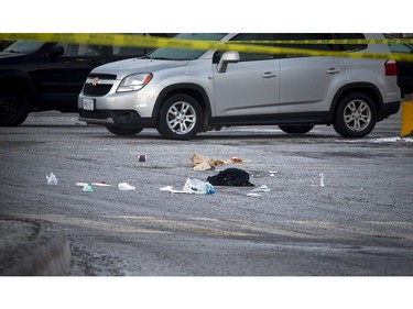 Clothing and McDonald's bags lay on the ground in the parking lot sectioned off with police tape. Abdullah Al-Tutunji, 20, was stabbed to death after a dispute in a McDonald's restaurant spilled outside near the intersection of Prince of Wales Drive and Meadowlands Drive early Sunday, Dec. 11.