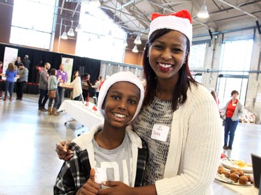 Ottawa realtor Deka Barre from the RE/MAX Hallmark Group Foundation for Giving and her son, Elyas Gesso, 10, volunteered at the Hamper Packing Day, held at the Horticulture Building at Lansdowne Park on Wednesday, December 21, 2016, in support of the Christmas Exchange Program run by the Caring and Sharing Exchange.