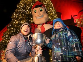 Ottawa Redblacks defensive back Brendan Gillanders shared the Grey Cup with kids, including excited four-year-old Abrahim Darwish, at the Christmas Market tree lighting in front of the Aberdeen Pavilion on Friday, Dec. 2, 2016.