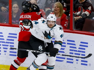 Ottawa Senators defenseman Erik Karlsson (65) gets a stick in the face from San Jose Sharks defenseman Marc-Edouard Vlasic (44) during NHL action at the Canadian Tire Centre on Wednesday December 14, 2016. Errol McGihon/Postmedia