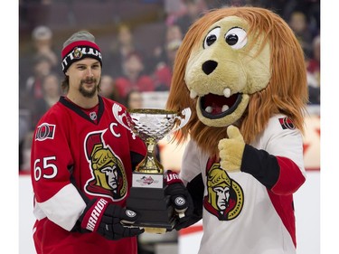 Ottawa Senators defenceman Erik Karlsson accepts his team's trophy from SpartaCat following the Sens Skills Competition.