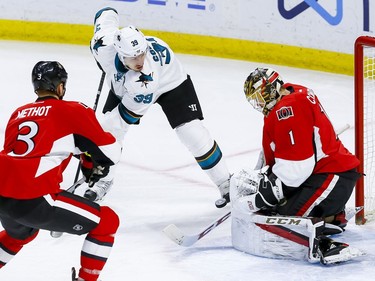 Ottawa Senators goalie Mike Condon (1) makes a save on San Jose Sharks center Logan Couture (39) as Sens Marc Methot looks on during NHL action at the Canadian Tire Centre on Wednesday December 14, 2016. Errol McGihon/Postmedia