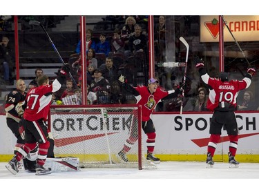 Ottawa Senators left-winger Ryan Dzingel celebrates scoring a goal with teammate Derick Brassard.