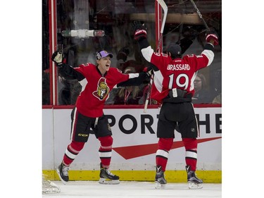 Ottawa Senators left-winger Ryan Dzingel celebrates scoring a goal with teammate Derick Brassard.