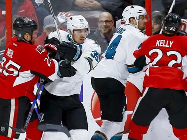 Ottawa Senators right wing Chris Neil (25) battles with San Jose Sharks center Logan Couture (39) during NHL action at the Canadian Tire Centre on Wednesday December 14, 2016. Errol McGihon/Postmedia