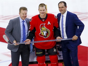 Ottawa Senators right wing Chris Neil (25) poses for photos with the other two Sens to achieve the same milestone Daniel Alfredsson and Chris Phillips during a ceremony to celebrate his 1000th NHL game prior to the game against the San Jose Sharks at the Canadian Tire Centre on Wednesday December 14, 2016. Errol McGihon/Postmedia