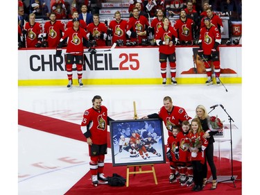 Ottawa Senators right wing Chris Neil (25) poses for photos with Sens captain Erik Karlsson along with his wife Caitlin and their three children Hailey, Cole, and Finn during a ceremony to celebrate his 1000th NHL game prior to the game against the San Jose Sharks at the Canadian Tire Centre on Wednesday December 14, 2016. Errol McGihon/Postmedia