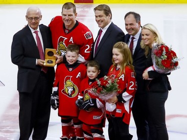Ottawa Senators right wing Chris Neil (25) poses for photos with Sens executives Bryan Murray, Randy Lee, and Pierre Dorion along with his wife Caitlin and their three children Hailey, Cole, and Finn during a ceremony to celebrate his 1000th NHL game prior to the game against the San Jose Sharks at the Canadian Tire Centre on Wednesday December 14, 2016. Errol McGihon/Postmedia