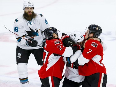 Ottawa Senators right wing Curtis Lazar (27) and Kyle Turris (7) go after San Jose Sharks defenseman Marc-Edouard Vlasic (44) after he hit Sens captain Erik Karlsson  (not pictured) in the face with his stick during NHL action at the Canadian Tire Centre on Wednesday December 14, 2016. Errol McGihon/Postmedia
