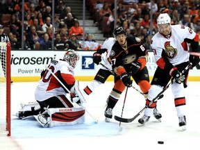 Ottawa Senators goalie Andrew Hammond gets some help from Mark Stone against Rickard Rakell of the Anaheim Ducks during the third period of a game at the Honda Center on Sunday, Dec. 11, 2016.