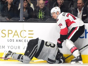 Mark Borowiecki of the Ottawa Senators checks Tyler Toffoli of the Los Angeles Kings into the boards for a boarding penalty during the first period.