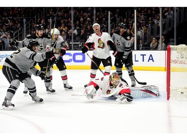 Trevor Lewis of the Los Angeles Kings scores a goal on Mike Condon of the Ottawa Senators as Marc Methot #3 and Anze Kopitar #11 react.