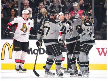 Alec Martinez of the Los Angeles Kings celebrates his power-play goal with Jeff Carter (77) and Tanner Pearson in front of Dion Phaneuf.