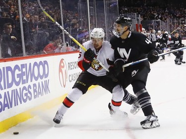 NEW YORK, NY - DECEMBER 18: Dennis Seidenberg #4 of the New York Islanders hits Cody Ceci #5 of the Ottawa Senators into the boards during the first period at the Barclays Center on December 18, 2016 in the Brooklyn borough of New York City.