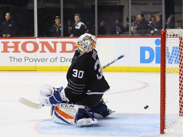 NEW YORK, NY - DECEMBER 18: A first period shot by Zack Smith #15 of the Ottawa Senators gets past Jean-Francois Berube #30 of the New York Islanders at the Barclays Center on December 18, 2016 in the Brooklyn borough of New York City.