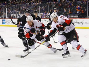 Chris Neil #25 and Casey Bailey #37 of the Ottawa Senators skates against the New York Islanders at the Barclays Center on December 18, 2016 in the Brooklyn borough of New York City.