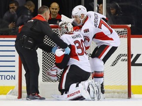 Senators goalie Andrew Hammond is assisted off the ice following a first-period injury against the New York Islanders at the Barclays Center on Sunday, Dec. 18, 2016 in the Brooklyn borough of New York City.
