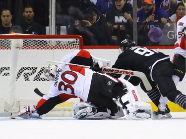 NEW YORK, NY - DECEMBER 18:  Andrew Hammond #30 of the Ottawa Senators is injured during the first period as he makes the save on John Tavares #91 of the New York Islanders at the Barclays Center on December 18, 2016 in the Brooklyn borough of New York City.