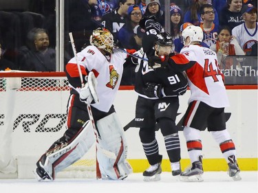 NEW YORK, NY - DECEMBER 18: Mike Condon #1 and Jean-Gabriel Pageau #44 of the Ottawa Senators combine to stop John Tavares #91 of the New York Islanders during the first period at the Barclays Center on December 18, 2016 in the Brooklyn borough of New York City.