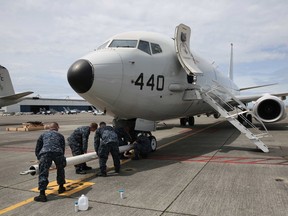160622-N-DC740-007 OAK HARBOR, Wash. (June 22, 2016) Sailors from Patrol Squadron (VP) 30 attach a tow bar to a P-8 Poseidon preparing to move it into Patrol and Reconnaissance Wing 10's newly renovated hangar six on Naval Air Station Whidbey Island's Ault Field for the first time. The P-8 is scheduled to replace the P-3, in naval service since the 1960s, no later than 2020.  (U.S. Navy photo by Mass Communication Specialist 2nd Class John Hetherington/Released)