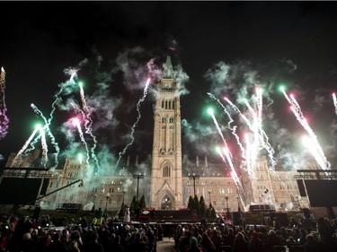 Pyrotechnics explode in front of Centre Block on Parliament Hill during the launch of Christmas Lights Across Canada, on Wednesday, Dec. 7, 2016 in Ottawa.