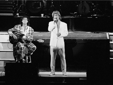 In this April 7, 1985 file photo, George Michael and Andrew Ridgeley of the British group WHAM! perform during a concert in Peking, China. Michael, who rocketed to stardom with WHAM! and went on to enjoy a long and celebrated solo career lined with controversies, has died, his publicist said Sunday, Dec. 25, 2016. He was 53.