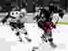 Anaheim Ducks defenseman Sami Vatanen (45), of Finland, sweeps the puck away from Ottawa Senators center Ryan Dzingel (18) during the first period of an NHL hockey game in Anaheim, Calif., Sunday, Dec. 11, 2016.