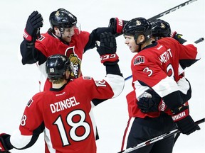 The Ottawa Senators' Bobby Ryan (9) celebrates his goal against the New Jersey Devils with teammates Ryan Dzingel (18) and Marc Methot (3) during the first period.