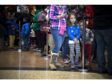 Seven-year-old Allie and three-year-old Emma Graham were caught peeking through the line at Mrs. Claus.