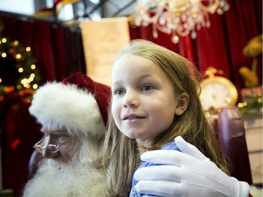 Allie Graham, 7, sits on Santa's knee.