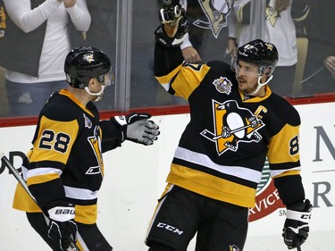 Pittsburgh Penguins captain Sidney Crosby celebrates his goal with Ian Cole in the first period.