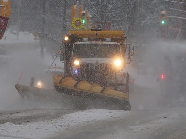 Snowplows were out in full force Monday morning following 15 centimetres of snow, slowing the roads and early-morning commute.  Julie Oliver/Postmedia