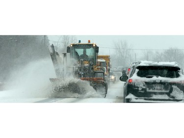 Snowplows were out in full force Monday morning following 15 centimetres of snow, slowing the roads and early-morning commute.