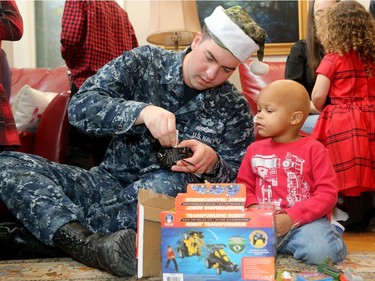 The big jolly fella arrived at Ronald McDonald House Thursday (Dec. 15/2016) as the United States Marine Corp. and US. Navy brought hundreds of toys for sick kids along with American ambassador, Bruce Heyman. Here, Kegan McPherson - who is being treated at CHEO for neuroblastoma - gets a hand putting together a transforming robot from US navy sailor, Taylor Pye.