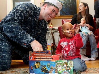 The big jolly fella arrived at Ronald McDonald House Thursday (Dec. 15/2016) as the United States Marine Corp. and US. Navy brought hundreds of toys for sick kids along with American ambassador, Bruce Heyman. Here, Kegan McPherson - who is being treated at CHEO for neuroblastoma - gets a hand putting together a transforming robot from US navy sailor, Taylor Pye.