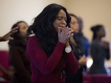 The congregation remembered two teenage girls killed in a traffic crash Friday with a service at Bible Way Ministries in Ottawa's south end Sunday December 11, 2016. Charlene Carnegie, a friend of the Muzaliwa family, prays with her hands clasped during Sunday's service.   Ashley Fraser/Postmedia