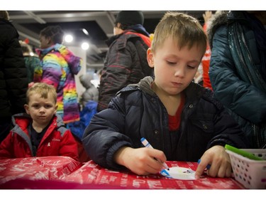 Soren Gilbert, 6, was focusing on colouring his paper that was transformed into a button with the help of an elf.