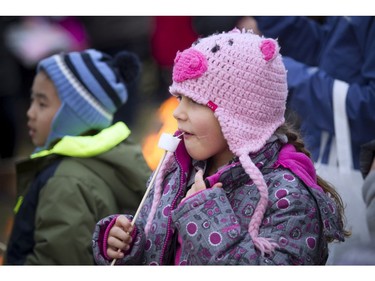 Genevieve Bernie, 7, takes a bite of her roasted marshmallow.