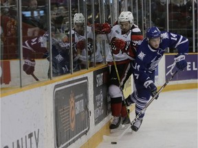 The Ottawa 67's Patrick White battles on the boards with Nathan Bastian of the Mississauga Steelheads in OHL action at TD Place on Sunday, Dec. 4, 2016.