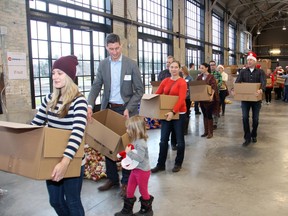 Volunteers help pack food hampers last year for the Caring and Sharing Exchange and its annual Christmas Exchange Program.
